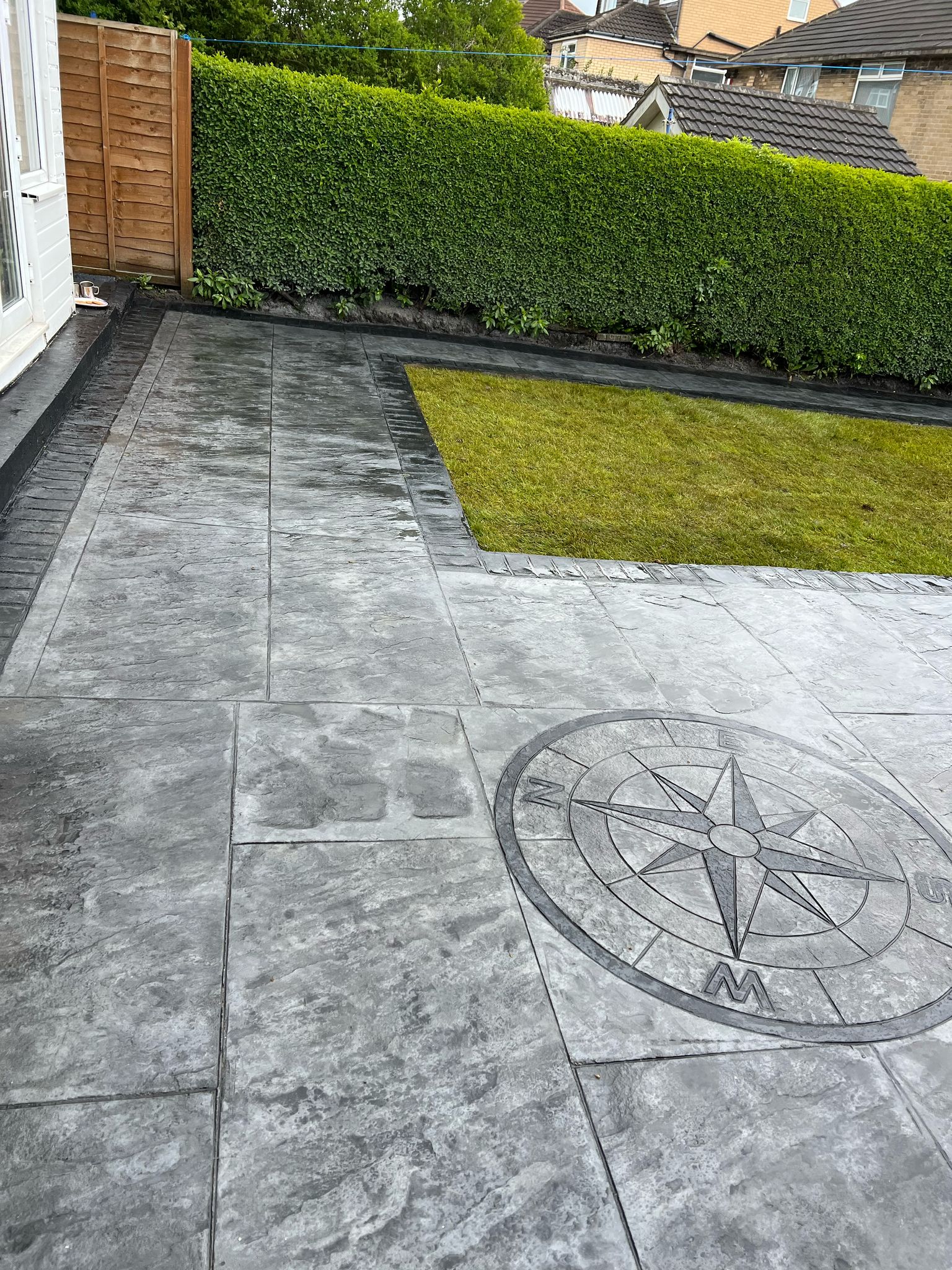 stamped concrete patio or driveway with a large tile or flagstone pattern